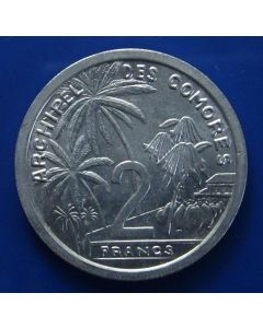 Comoros  2 Francs  1964	 Unc – Palmtrees and coconuts surrounding denomination.